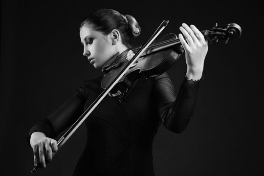 a woman playing a violin